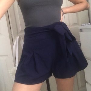 Pleated navy blue skort with self tie belt